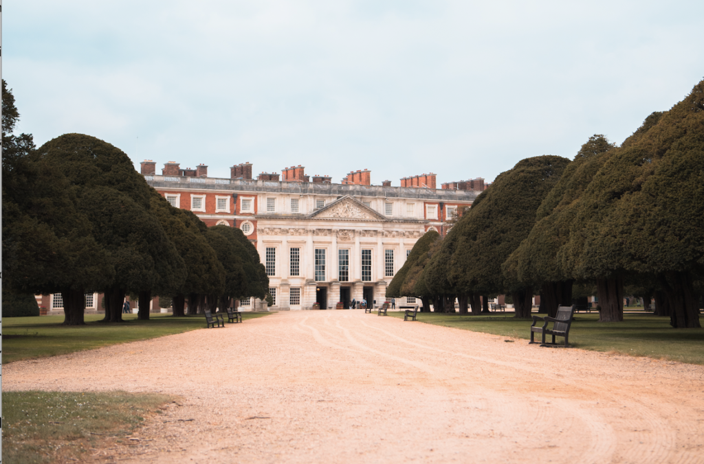 Hampton Court Palace at the end of a tree lined path