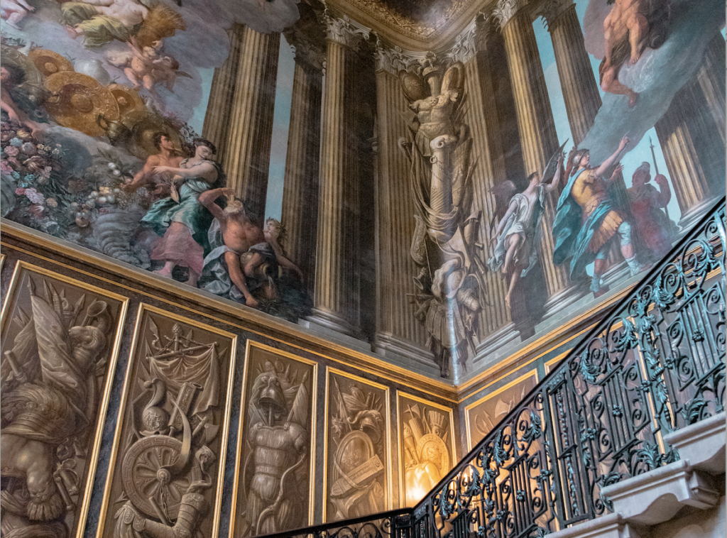 Grand hall with black iron staircase and angelic mural